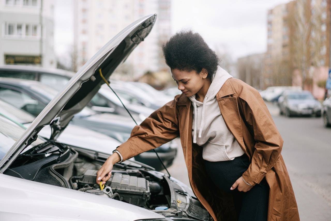 african-woman-fixing-a-car-engine